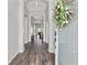 Inviting hallway with wood-look flooring, neutral walls, and an open view to the living spaces at 4214 Canongate Ct, Spring Hill, FL 34609