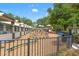 Community playground with various structures and seating surrounded by a fence at 4124 Canongate Ct, Spring Hill, FL 34609