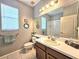Bright bathroom with a double vanity and large mirror at 4214 Canongate Ct, Spring Hill, FL 34609