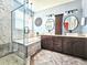 Bathroom featuring double sink vanity, glass enclosed shower, and soaking tub with modern finishes at 4214 Canongate Ct, Spring Hill, FL 34609