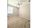 Neutral bedroom with plush carpet, ceiling fan, and a window for natural light at 4214 Canongate Ct, Spring Hill, FL 34609
