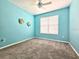 Cheerful bedroom with blue walls, plush carpet, and a window for natural light at 4214 Canongate Ct, Spring Hill, FL 34609