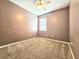 Cozy bedroom with plush carpet, ceiling fan, and a window for natural light at 4214 Canongate Ct, Spring Hill, FL 34609
