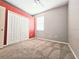 Simple bedroom with plush carpet, neutral tones, and a double closet for storage at 4214 Canongate Ct, Spring Hill, FL 34609
