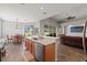 Open kitchen featuring wood floors, stainless appliances, white counters, and an adjacent dining area with backyard views at 4214 Canongate Ct, Spring Hill, FL 34609