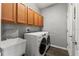 Modern laundry room with cabinets, sink, and newer washer and dryer at 4214 Canongate Ct, Spring Hill, FL 34609