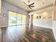 Spacious living room featuring vaulted ceilings, tile floors, recessed lighting, and sliding glass doors to the backyard at 4214 Canongate Ct, Spring Hill, FL 34609