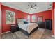 Inviting primary bedroom featuring tray ceiling, wood-look floors, and large windows with natural light at 4214 Canongate Ct, Spring Hill, FL 34609