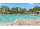 Large outdoor swimming pool with pool furniture and green landscaping at 4214 Canongate Ct, Spring Hill, FL 34609