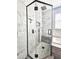 Luxurious marble and glass shower features modern fixtures, gray accent tiles, and a built-in bench at 4214 Canongate Ct, Spring Hill, FL 34609