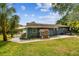Spacious backyard boasts a playhouse, patio seating, and lush green lawn, perfect for Gathering gatherings at 4403 W Bay Court Ave, Tampa, FL 33611