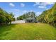 Spacious backyard with lush green grass and a privacy fence at 4403 W Bay Court Ave, Tampa, FL 33611