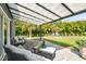 There's plenty of outdoor living space to relax in the shade on this patio surrounded by mature trees at 4403 W Bay Court Ave, Tampa, FL 33611
