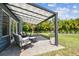 The home has an outdoor seating area and is surrounded by lush landscaping and trees at 4403 W Bay Court Ave, Tampa, FL 33611