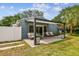 Backyard patio is ideal for relaxing, with ample seating and serene views of the landscaped lawn and garden at 4403 W Bay Court Ave, Tampa, FL 33611