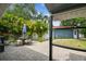 Paver patio with outdoor seating, umbrella, and lush tropical landscaping creating a private backyard oasis at 4403 W Bay Court Ave, Tampa, FL 33611