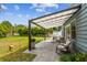 Covered backyard patio offering a relaxed setting with comfortable seating, lush greenery, and privacy at 4403 W Bay Court Ave, Tampa, FL 33611