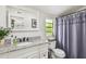 Updated bathroom featuring granite vanity, white subway tile and shower with curtain at 4403 W Bay Court Ave, Tampa, FL 33611