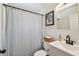 Clean bathroom featuring a shower with curtain, modern vanity, and white subway tile at 4403 W Bay Court Ave, Tampa, FL 33611