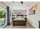 This bedroom features wood floors, ceiling fan, and a sliding glass door to the patio at 4403 W Bay Court Ave, Tampa, FL 33611
