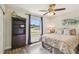 Cozy bedroom with ample natural light, wood-look flooring, ceiling fan and closet space at 4403 W Bay Court Ave, Tampa, FL 33611