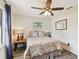 Cozy bedroom features a ceiling fan, patterned bedding, and a window for natural light at 4403 W Bay Court Ave, Tampa, FL 33611