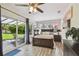 This is a lovely bedroom, complete with fan, en suite bath, wood floors, and sliding glass door to patio at 4403 W Bay Court Ave, Tampa, FL 33611