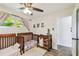 Bright Bedroom with two wood cribs, changing table and view from the window at 4403 W Bay Court Ave, Tampa, FL 33611