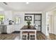 Bright dining area features a rustic table, white chairs, and a decorative sliding barn door at 4403 W Bay Court Ave, Tampa, FL 33611