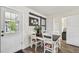Dining area featuring a rustic table, white chairs, and a white door at 4403 W Bay Court Ave, Tampa, FL 33611