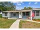 Close up of the front of the home featuring an American Flag and a sidewalk leading to the door at 4403 W Bay Court Ave, Tampa, FL 33611