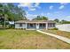 Charming single-story home featuring a well-manicured lawn and inviting walkway leading to a white front door at 4403 W Bay Court Ave, Tampa, FL 33611
