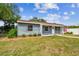 Charming single-story home featuring a well-manicured lawn and inviting walkway leading to a white front door at 4403 W Bay Court Ave, Tampa, FL 33611