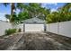 Detached garage with a basketball hoop and a driveway at 4403 W Bay Court Ave, Tampa, FL 33611