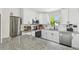 Bright kitchen with white cabinets, granite countertops, and stainless steel appliances at 4403 W Bay Court Ave, Tampa, FL 33611