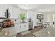 Modern kitchen with white cabinets, granite counters, tile backsplash, and stainless steel appliances at 4403 W Bay Court Ave, Tampa, FL 33611