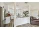 Open kitchen with stainless steel appliances, granite countertops, and a breakfast bar overlooking living area at 4403 W Bay Court Ave, Tampa, FL 33611