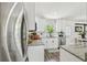 Bright kitchen with stainless steel appliances, white cabinets, granite countertops and breakfast bar at 4403 W Bay Court Ave, Tampa, FL 33611