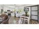 Modern kitchen with white cabinets, stainless steel appliances, and wood-look floors, adjacent to dining area at 4403 W Bay Court Ave, Tampa, FL 33611