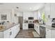 Spacious kitchen with granite countertops, white cabinetry, and stainless steel appliances at 4403 W Bay Court Ave, Tampa, FL 33611