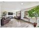 Bright living room with hardwood floors, comfortable seating, and large windows providing ample natural light at 4403 W Bay Court Ave, Tampa, FL 33611