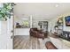 Inviting living room with modern flooring, open layout, and seamless connection to the kitchen and dining area at 4403 W Bay Court Ave, Tampa, FL 33611
