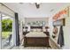 Spacious main bedroom with dark wood furniture, sliding glass doors and backyard views at 4403 W Bay Court Ave, Tampa, FL 33611