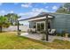 Relaxing patio area with a pergola, comfortable seating, and well-maintained landscaping at 4403 W Bay Court Ave, Tampa, FL 33611