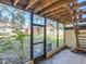 This home has a screened patio and stairs leading to the yard at 533 E Curlew Pl # 533, Tarpon Springs, FL 34689