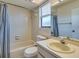Clean bathroom with a tiled shower-tub combo, white vanity, and a large mirror, creating a refreshing space at 533 E Curlew Pl # 533, Tarpon Springs, FL 34689