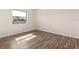 Bright bedroom boasts wood-look floors and natural light from a window at 533 E Curlew Pl # 533, Tarpon Springs, FL 34689