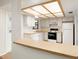Functional kitchen with white cabinets, modern appliances, and an eat-in counter perfect for quick meals at 533 E Curlew Pl # 533, Tarpon Springs, FL 34689