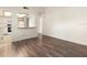 An airy living room is featured with wood floors and a passthrough to the kitchen, creating an open feel at 533 E Curlew Pl # 533, Tarpon Springs, FL 34689