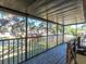 This screened patio has wood floors and metal railings at 533 E Curlew Pl # 533, Tarpon Springs, FL 34689